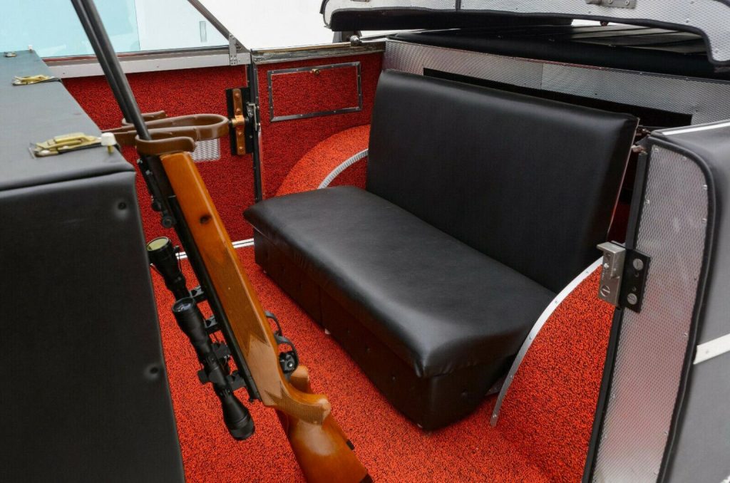 un rifle de caza guardado en su soporte en el asiento trasero del Mohs Sarafikar